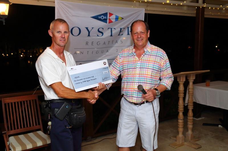 Director of Antigua and Barbuda Search and Rescue, Jonathan Cornelius, receiving US$1280 of donations from Oyster owners, presented by David Tydeman, CEO Oyster Group - photo © Oyster Yachts / Tim Wright / www.photoaction.com