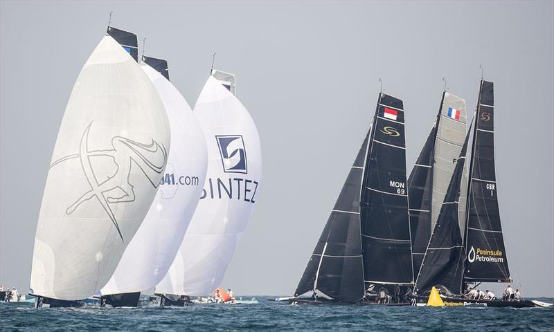 Close windward mark roundings on day 2 of the RC44 Oman Cup photo copyright Nico Martinez / MartinezStudio taken at  and featuring the RC44 class