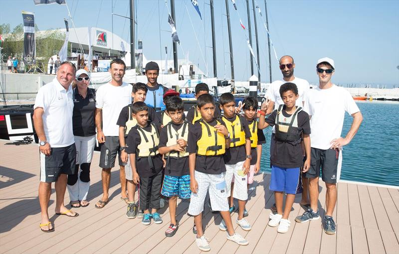 RC44 tacticians with the Wave Racing Club Optimist sailors on day 3 of the RC44 Oman Cup photo copyright Nico Martinez / MartinezStudio taken at  and featuring the RC44 class