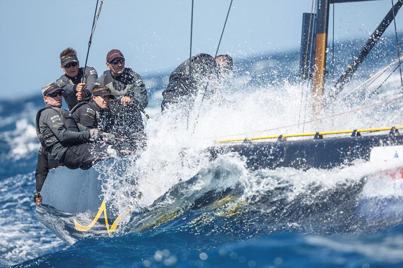 Team Nika plows through a big wave downwind on the final day of the RC44 Valletta Cup fleet racing - photo © www.MartinezStudio.es