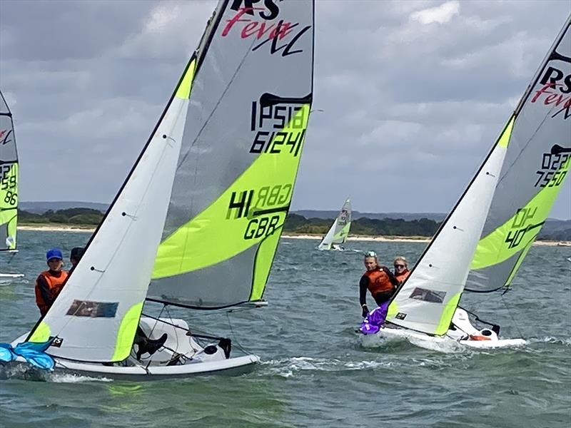 Dirk & Jonny chased by Freya & Joanna at the 70th National Schools Championship held at Itchenor photo copyright Kate Hutchinson taken at Itchenor Sailing Club and featuring the RS Feva class