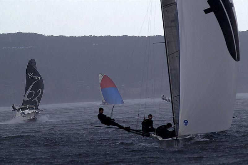 Thurlow Fisher leads lap one in driving rain and low visibility in race 4 of the 18ft Skiff Club Championship photo copyright Frank Quealey taken at  and featuring the 18ft Skiff class