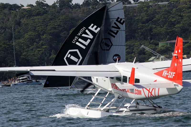 The Ilve crew had to manouvre their skiff between a light plane taking off and a party cruise boat on Sydney Harbour during race 2 of the 18ft Skiff Australian Championship - photo © Frank Quealey