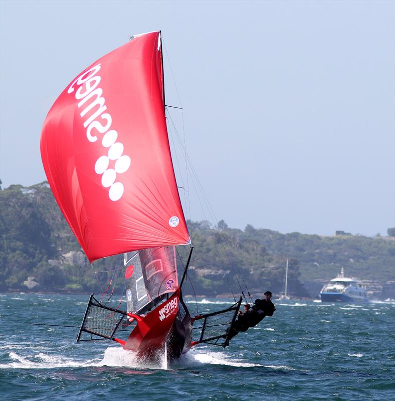 The Smeg crew show their form on a downwind leg in a North-East wind as a Manly Ferry approaches in the background photo copyright Frank Quealey taken at Australian 18 Footers League and featuring the 18ft Skiff class