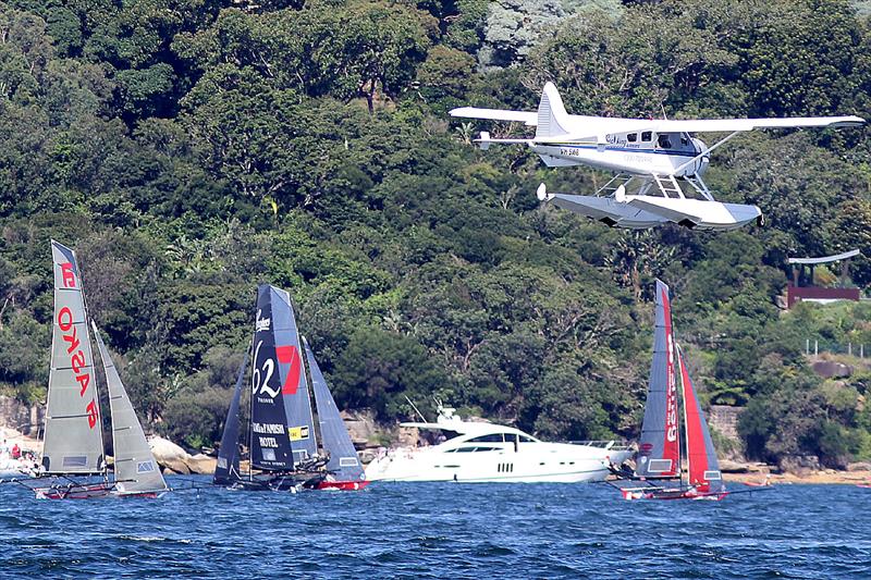 Light wind and a small sea plane test the leaders as they approach the final rounding mark in Rose Bay during the 18ft Skiff President's Trophy photo copyright Frank Quealey taken at Australian 18 Footers League and featuring the 18ft Skiff class