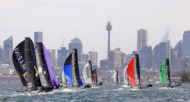 Spinnakers and the city - 2024 JJ Giltinan Championship photo copyright SailMedia taken at Australian 18 Footers League and featuring the 18ft Skiff class