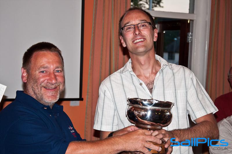 Cliff Milliner receiving the Supernova national champions trophy from class chairman Paul Earnshaw photo copyright www.SailPics.co.uk taken at Saundersfoot Sailing Club and featuring the Supernova class