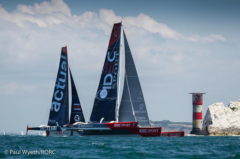 Francis Joyon's IDEC and Yves Le Blevec's Ultim Actual, sailed by Ronan Dehayes, pass the Needles during the 2021 Cowes-Dinard-St Malo Race photo copyright Paul Wyeth / RORC taken at Royal Ocean Racing Club and featuring the Trimaran class