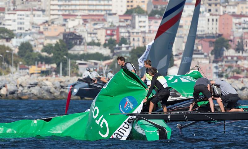 Groupama sailing team recover their rig after loosing their new mast during race four on day 1 of Act 6, Istanbul photo copyright Lloyd Images taken at  and featuring the Extreme 40 class