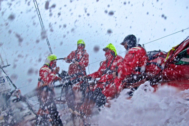 Water gushes over the deck onboard CAMPER with Emirates Team New Zealand during leg 4 of the Volvo Ocean Race