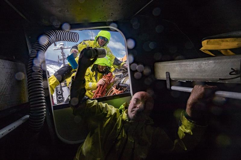 Volvo Ocean Race Leg 6 to Auckland, day 09 on board Brunel. Bouwe Bekking gives a bottle of water to Alberto Bolzan while Andrew Cape is cleaning up the pit. 15 February photo copyright Yann Riou / Volvo Ocean Race taken at  and featuring the Volvo One-Design class