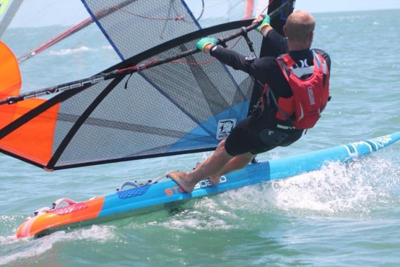 Cam Harrison showing his winning style (and washing up gloves!) photo copyright David Bell taken at Royal Queensland Yacht Squadron and featuring the Windsurfing class