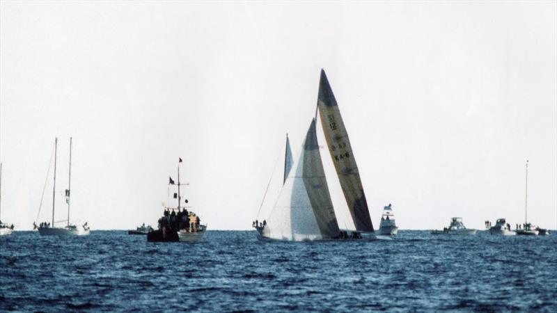 Australia II about to cross the finish line marked by the Committee Boat, Black Knight, to win the America's Cup - September 26, 1983 photo copyright Paul Darling taken at New York Yacht Club and featuring the 12m class