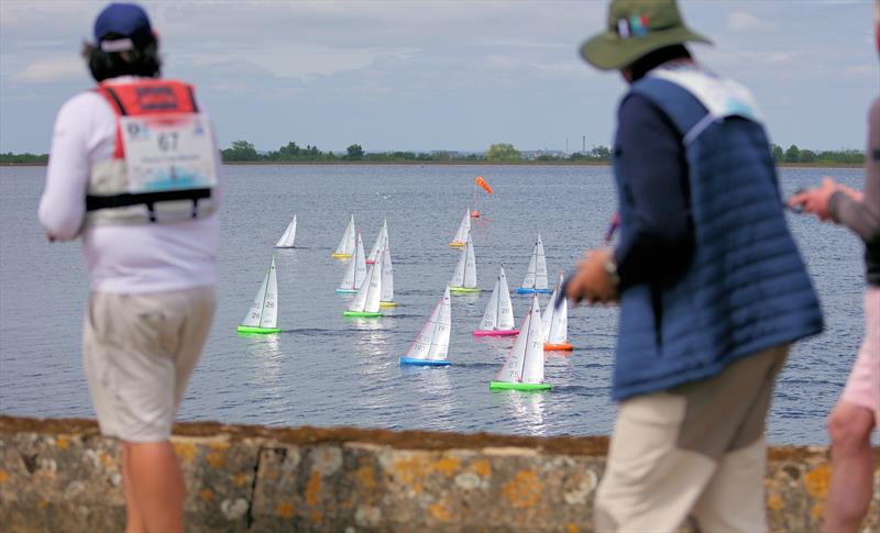 2026 IOM Worlds at Datchet Water Day 4 - Skippers walk the wall watching their yachts photo copyright Mark Jardine taken at Datchet Water Sailing Club and featuring the One Metre class