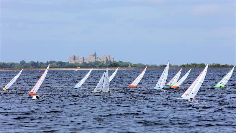 2026 IOM Worlds at Datchet Water Day 4 - The fleet cross tacks upwind in front of Windsor Castle photo copyright Mark Jardine taken at Datchet Water Sailing Club and featuring the One Metre class