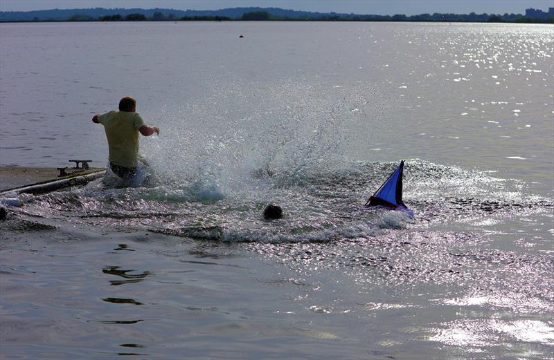 The winners celebrating with a dunk at the 2026 IOM Worlds photo copyright Mark Jardine taken at Datchet Water Sailing Club and featuring the One Metre class