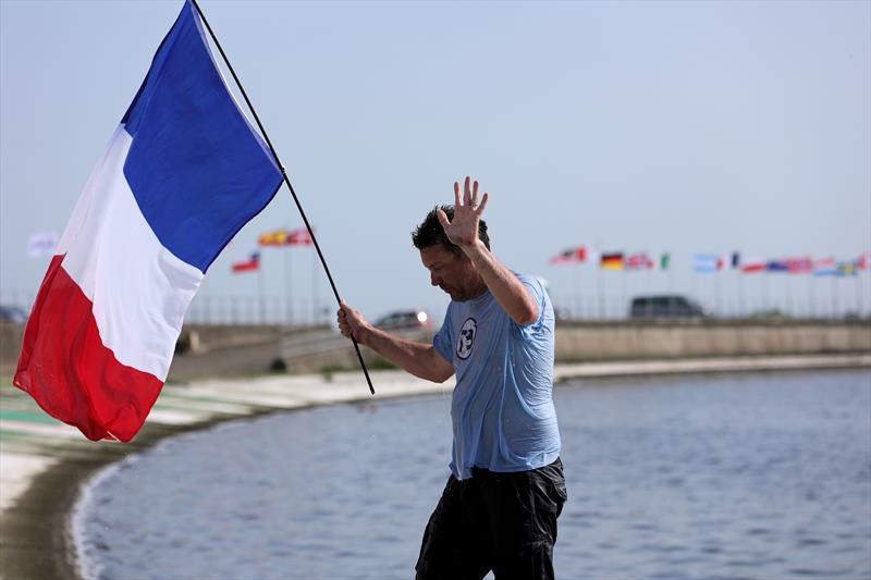 The winners celebrating with a dunk at the 2026 IOM Worlds - Alexis holding the French flag photo copyright Mark Jardine taken at Datchet Water Sailing Club and featuring the One Metre class