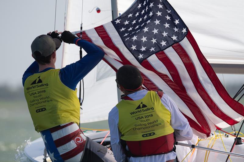 USA Mens 420 crew raise the Stars and Stripes on Day 4 of the Youth Sailing World Championships in Corpus Christi, Texas photo copyright Jen Edney / World Sailing taken at  and featuring the 420 class