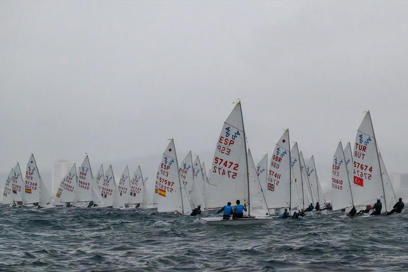 The 420 fleet sailing in the middle of a rain shower - 49th Palamós Christmas Race photo copyright Oscar Torveo taken at  and featuring the 420 class