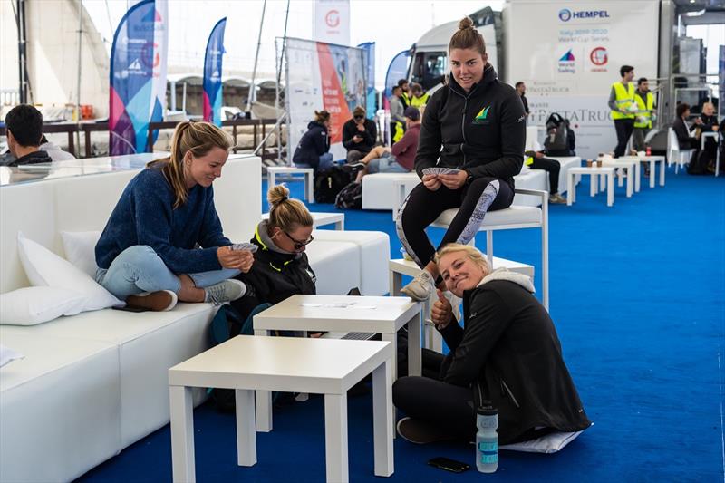 A game of cards filled in time for some of the 49erFX sailors - Genoa World Cup Series 2019 photo copyright Beau Outteridge taken at  and featuring the 49er FX class
