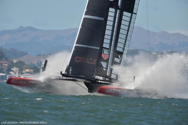 A big splashdown for ORACLE TEAM USA as they round mark 1 during the 34th America's Cup deciding race 19 photo copyright Ricardo Pinto / ACEA taken at  and featuring the AC72 class