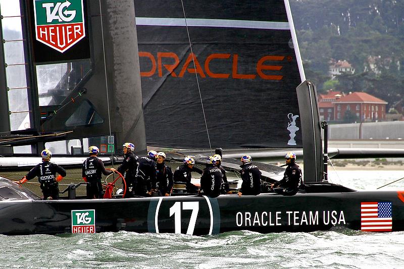 Joe Spooner (second from right) waits between races on the crucial Day 3 of the 2013 America's Cup photo copyright Richard Gladwell Sail-World.com taken at  and featuring the AC72 class