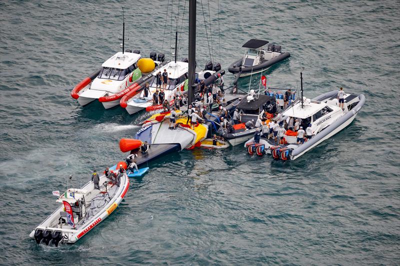 The America's Cup support teams work together to save NYYC American Magic's Patriot after a huge capsize on day 3 of the PRADA Cup photo copyright COR36 / Studio Borlenghi taken at  and featuring the AC75 class