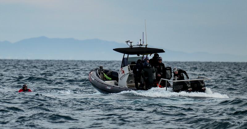 Nils Theuninck is retrieved  by a chase boat - Alinghi Red Bull Racing -  AC75 - January 12, 2023 - Barcelona photo copyright Alex Carabi / America's Cup taken at Société Nautique de Genève and featuring the AC75 class