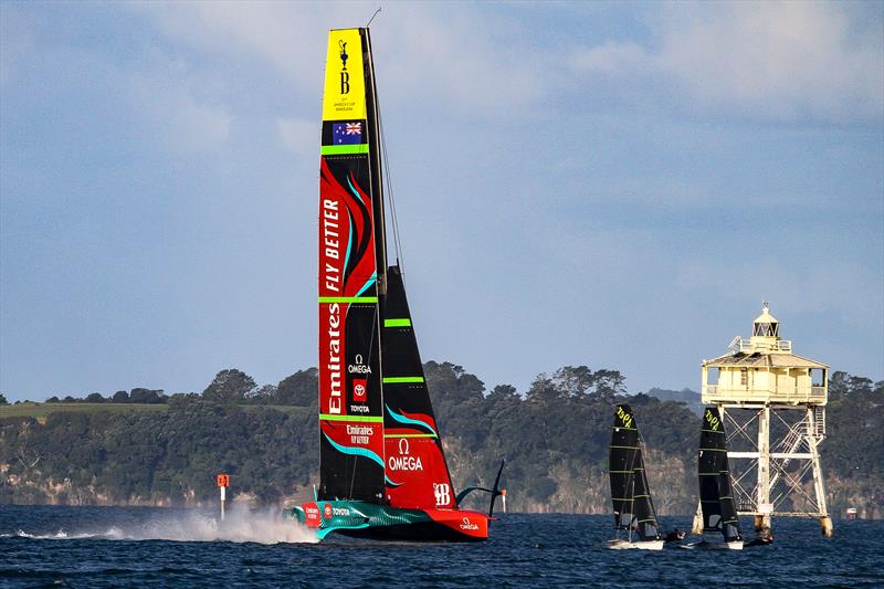 America's Cup Champion Te Rehutai concludes its final sailing day in Auckland, passing Bean Rock and two Olympic 49ers - May 2023 photo copyright Richard Gladwell - Sail-World.com / nz taken at Royal New Zealand Yacht Squadron and featuring the AC75 class