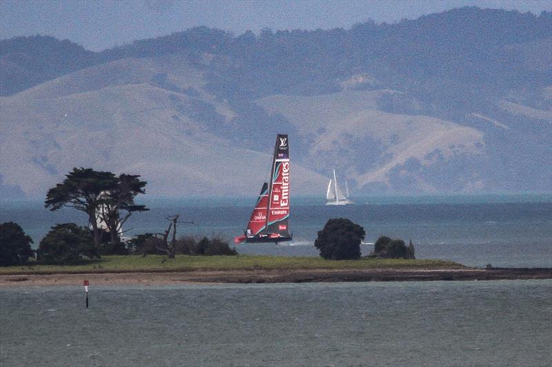 Emirates Team New Zealand behind the spit on Browns Island - AC75, Day 8 - March 30, 2026 photo copyright Richard Gladwell / Sail-World.com/nz taken at Royal New Zealand Yacht Squadron and featuring the AC75 class