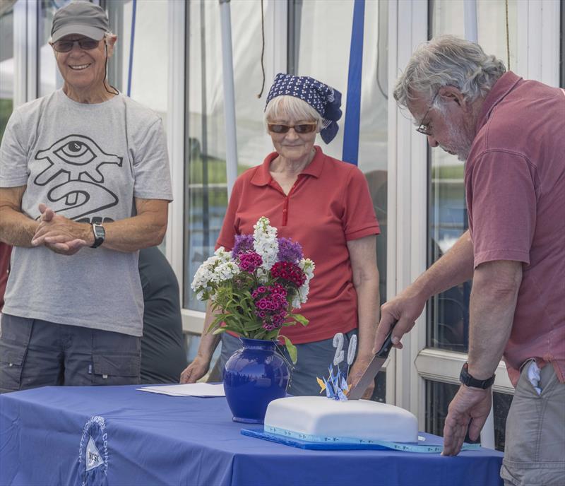 Cutting the 20th Anniversery cake during the Notts County Hansa TT photo copyright David Eberlin taken at Notts County Sailing Club and featuring the Hansa class