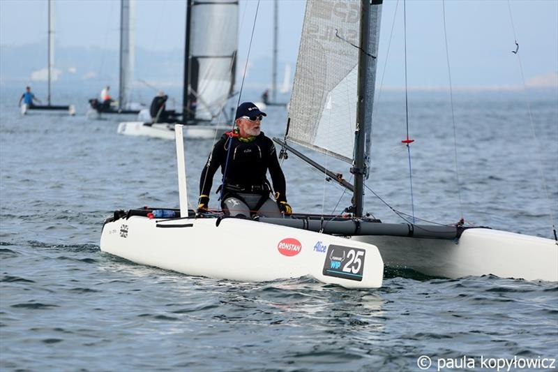 GBR light wind specialist Pete Boxer in his typical downwind pose on day 1 of the A Class Cat Worlds at the WPNSA photo copyright Paula Kopylowicz taken at Weymouth & Portland Sailing Academy and featuring the A Class Catamaran class