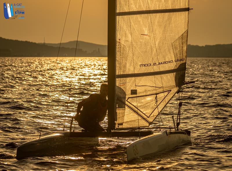 A-Cat Worlds at Toulon, France Day 3 - Evening sailing in Toulon, Marco Radman comes in for the finish photo copyright Gordon Upton / www.guppypix.com taken at Yacht Club de Toulon and featuring the A Class Catamaran class