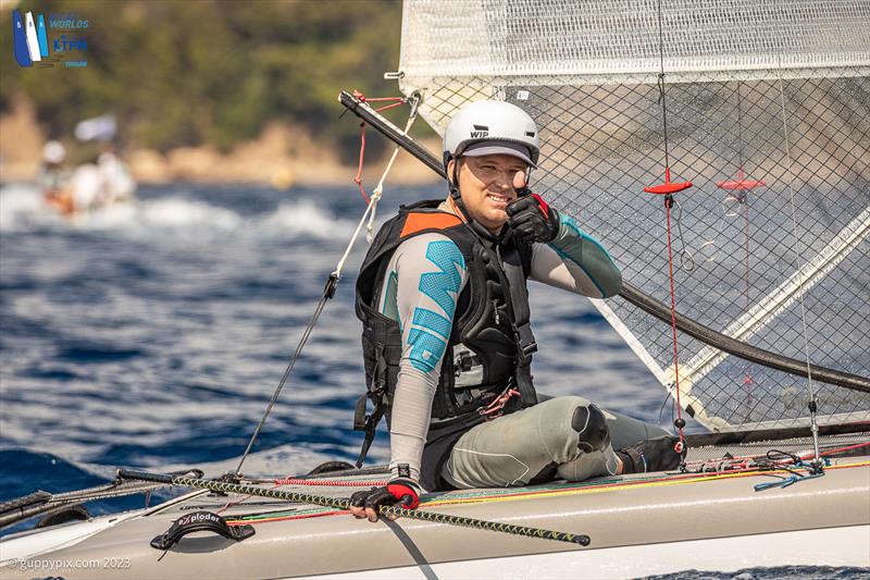 A-Cat Worlds at Toulon, France Day 5 - Adam Beattie AUS 14 happy with his 3rd in the first race photo copyright Gordon Upton / www.guppypix.com taken at Yacht Club de Toulon and featuring the A Class Catamaran class
