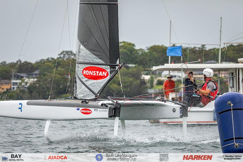 Australian A-Cat Nationals on Lake Macquarie Day 1 - Darren Bundock at the finish on his Exploder Open category boat.  Bundy is lying in 3rd after day one photo copyright Gordon Upton taken at South Lake Macquarie Amateur Sailing Club and featuring the A Class Catamaran class