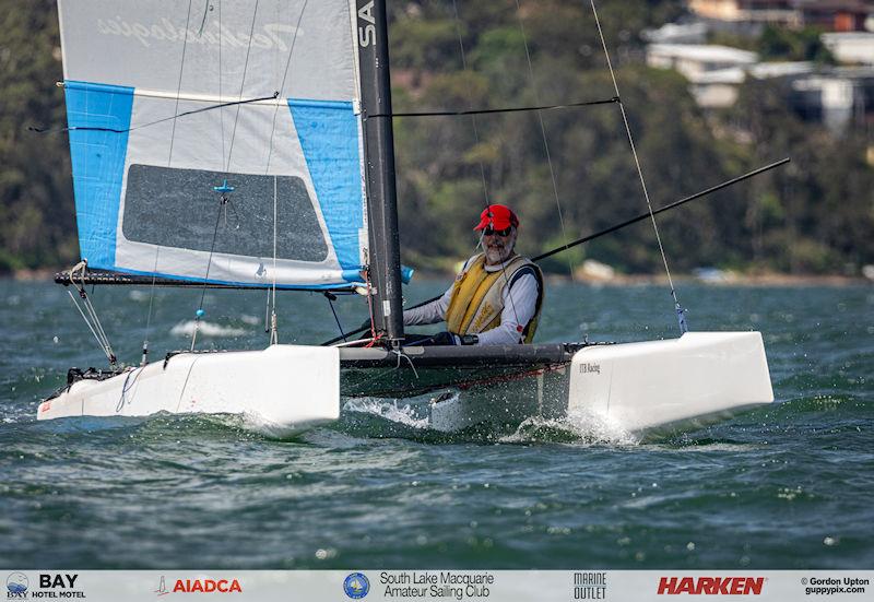 Australian A-Cat Nationals on Lake Macquarie Day 3 - Past class president, Ian Johnson, loving sailing his old Gel-Tek Flyer Classic - older boats in the Classic fleet can prove to be huge fun and close racing photo copyright Gordon Upton / www.guppypix.com taken at South Lake Macquarie Amateur Sailing Club and featuring the A Class Catamaran class