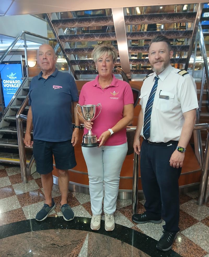 Overall winners Judy and Paul Armstrong being congratulated by NorthLink Ferries MV HROSSEY Customer service manager Greg Mouat - Albacore Scottish and European Championships at the Shetland Islands photo copyright Gilbert Williamson plus Albacore supporters taken at South Yell Boating Club and featuring the Albacore class