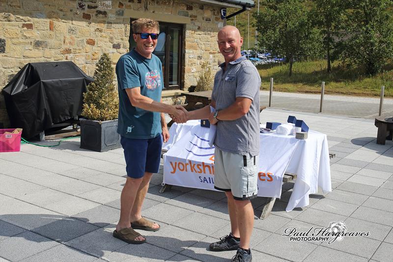 Ian Smith, Blaze Northern Champion, receiving congratulations from Race Officer Terry Pressdee photo copyright Paul Hargreaves taken at Yorkshire Dales Sailing Club and featuring the Blaze class