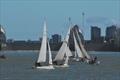 Bosun dinghies compete against a backdrop of the raised Thames Barrier at the London Regatta 2015 © Clive Reffell
