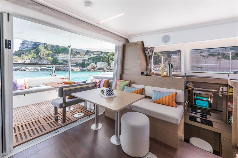 Lagoon 38 interconnectivity inside and out allows for the long lunch or intimate coffee table inside - your call - photo © Julien Gazeau