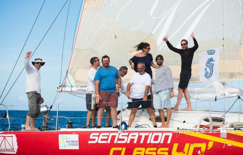 A jubilant crew on Sensation Class 40 celebrate their finish in the RORC Transatlantic Race photo copyright Arthur Daniel & Orlando K Romain / RORC taken at  and featuring the Class 40 class