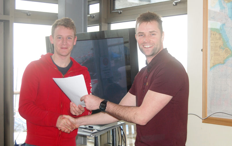 The winning sailor, Mike Barnes, being presented with the paperwork for his boat by BCA Chairman Ed Presley photo copyright DavidHenshallMedia taken at Hayling Island Sailing Club and featuring the Contender class