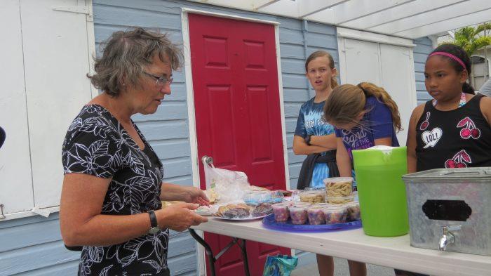 Man-O-War Cay: Our hostess, Connie van Bussel, negotiates for cookies from schoolkids saving for a trip to Eleuthera. - photo © Stephen and Nancy Carlman
