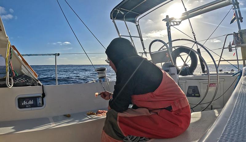 Eating sashimi in the cockpit - Blue Moon II circumnavigation - photo © Tristan Gourlay