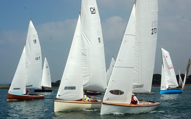 Bosham Classic Boat Revival: The National 18s use their spread of sail to power off the line, but behind them Charlie Morgan in Merlin Rocket 1978 is already see the opportunity to break clear into better pressure photo copyright Dougal@davidhenshallmedia taken at Bosham Sailing Club and featuring the Classic & Vintage Dinghy class