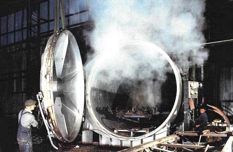 Opening up the autoclave with the steamed wooden structure inside, sheathed in rubber - photo © G Currey