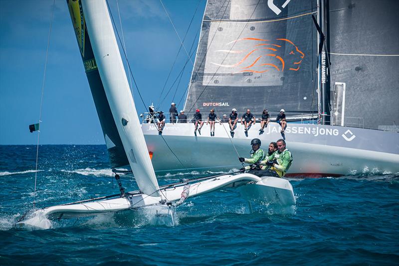 Diam24 Karibuni blasts past VO65 Janssen de Jong on the windward side of St. Maarten in the final leg of the Around the Island Race at the 2022 St. Maarten Heineken Regatta photo copyright Laurens Morel taken at Sint Maarten Yacht Club and featuring the Diam 24OD class