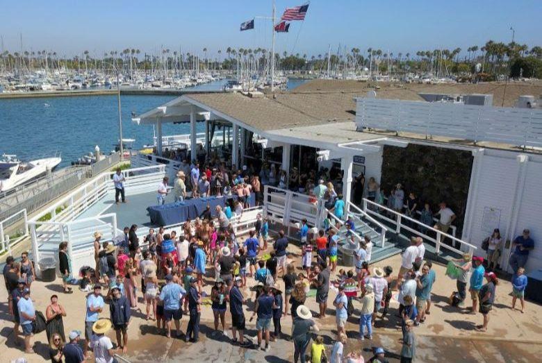 A crowd gathers for the presentation of the Jessica Uniack Memorial Trophy, awarded to the winning sailing of the largest fleet. - photo © Cameron MacLaren
