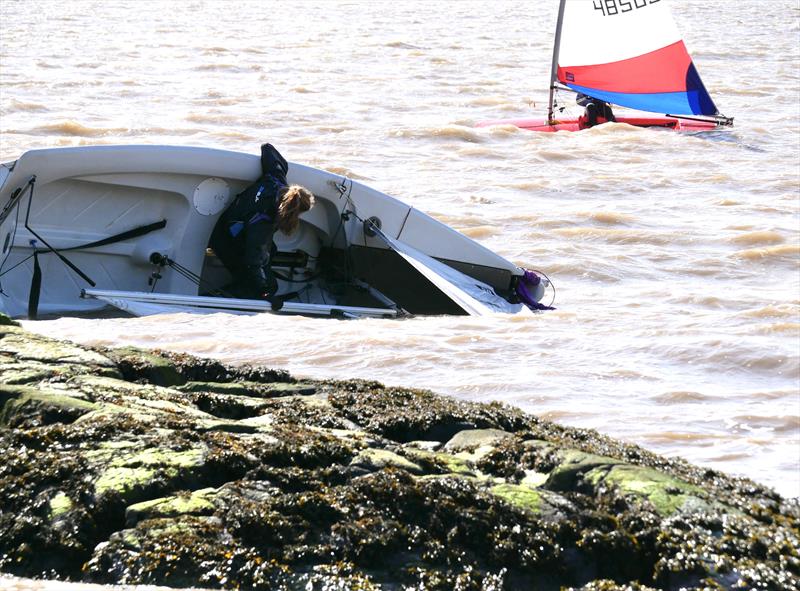 Easter Eggstravaganza in Kippford: James Bishop and Noa Crowley in a bit of bother near the rocks while Lucy Leyshon sails on to her 4th overall in the series photo copyright Margaret Purkis taken at Solway Yacht Club and featuring the Dinghy class