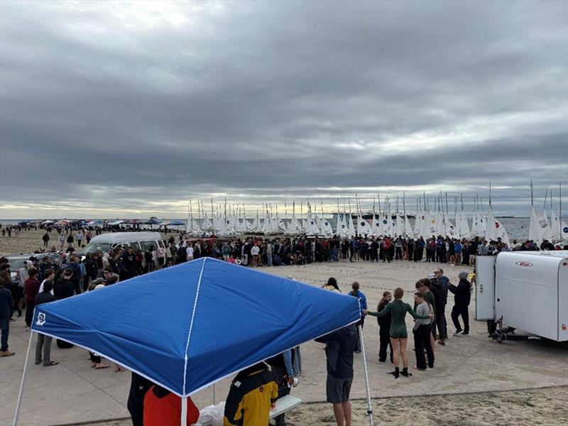 Over 400 participating sailors, coaches, parents, and regatta volunteers gather for the Saturday Competitors briefing at the Long Beach Granada Ramp under menacing skies photo copyright United States Sailing Center taken at  and featuring the Dinghy class